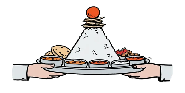 An overflowing Indian thali platter piled high with rice, curries, breads and sweets.